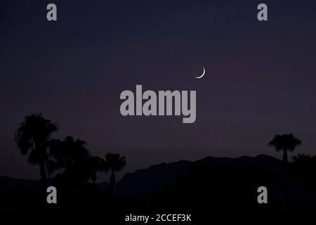 Las Vegas, Nevada, USA. 20th Aug, 2020. A waxing crescent Moon sets in the western skies above Las Vegas, Nevada on August 20, 2020. A waxing crescent is the first phase after the New Moon. Credit: David Becker/ZUMA Wire/Alamy Live News Stock Photo