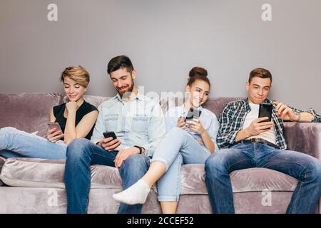 young men and women are wasting their time. students are browsing the Net indoors. close up shot. mobile generation Stock Photo