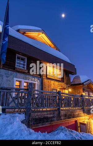 Europe, Switzerland, Valais, Belalp, moon over the Hamilton Lodge in Belalp Stock Photo