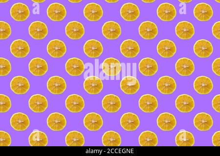Seamless pattern of yellow lemon slices on an purple background. Stock Photo