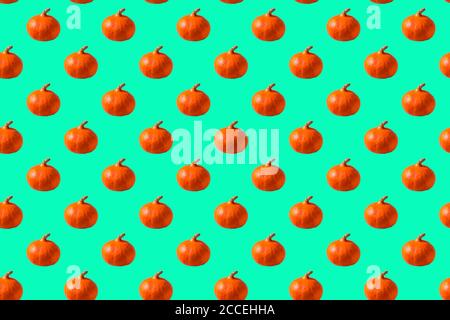 Seamless Pattern made with pumpkin vegetable on neo mint background. Stock Photo