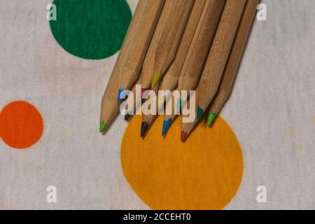 colored crayons lined up on a colored plane, horizontal image Stock Photo