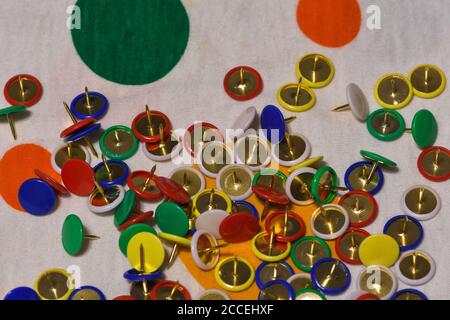 Scattered thumbtacks on a colored plane, horizontal image Stock Photo