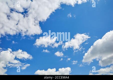 Blue skies with white and grey cumuli clouds. Bulbous and billowing white and dark grey clouds in the blue sky Stock Photo