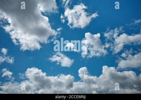 Cotton-like cumulus clouds in the glorious azure sky. Heavenly element. Background for forecast and meteorology illustration Stock Photo