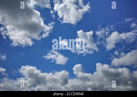 Puffy cumulus clouds forming a towering air mass in blue sky Stock ...