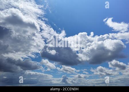 Sunlit cumulus humilis clouds in blue sky. Background for forecast and meteorology illustration Stock Photo