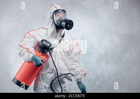 coronavirus pandemic, disinfection against COVID-19 virus. professional disinfector in protective clothing, suit fight with pandemic health risk, remo Stock Photo