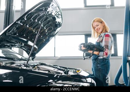 girl is happy as her vehicle is in good working order.side photo. successful work Stock Photo