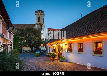 Szentendre, Hungary - August 17, 2018: Restaurant and a church in the old town of Szentendre in Hungary. Stock Photo