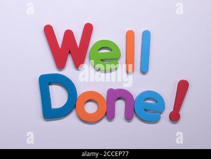 'Well done!' written with color sponge Stock Photo