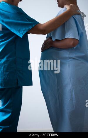 Midwife with woman in early labour Stock Photo