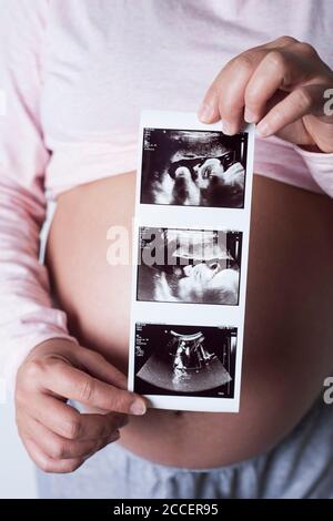 Pregnant woman holding baby scans Stock Photo