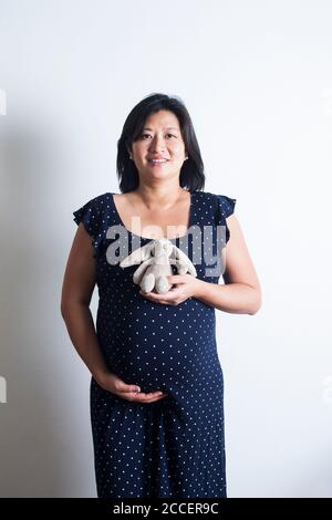 Pregnant woman holding soft toy Stock Photo