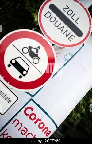 Border custom traffic sign in front of corona warning information placard at germany to swiss Stock Photo