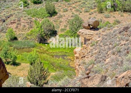A pair of balanced rocks on a cliff overlooking the Verde River near Paulden AZ. This location is known as the Upper Verde River Wildlife Area. Stock Photo