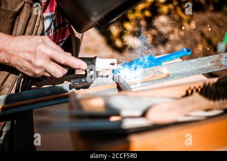 Arc welding on a workpiece with flying sparks, hobby craftsmen Stock Photo