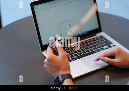 close up hands holding credit card and using laptop computer on table.blur background Stock Photo