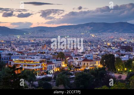 View of Thissio quarters in Athens from Areopagus hill at sunset. Stock Photo