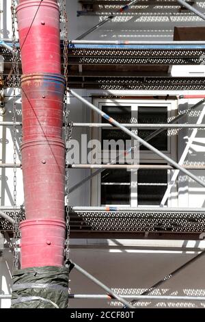 Construction site, downpipe for building rubble on the facade of a scaffolded house, Bremen, Germany, Europe Stock Photo