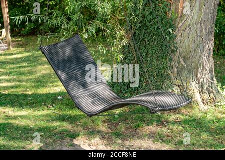 Hanging couch with rope, garden, tree trunk, Lower Austria Stock Photo