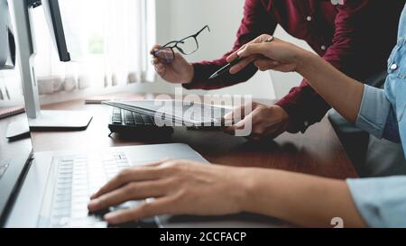 Team of Programmer working to find solution to problem and coding technologies in a software developing company office Stock Photo