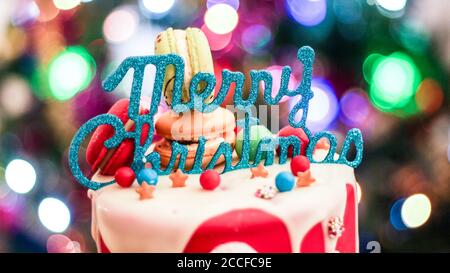 Merry Christmas topper on a santa themed christmas cake Stock Photo