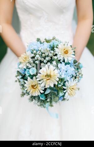 Close up of a wedding bouquet hand held by a wedding bride Stock Photo
