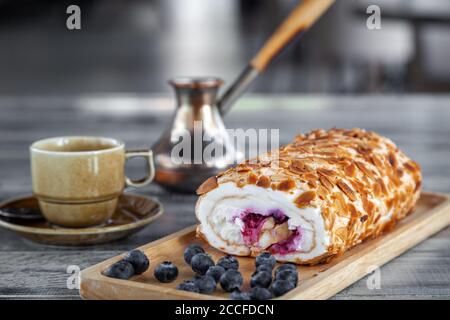 Cup of coffee, coffee in copper turk, dessert on a wooden plate Stock Photo