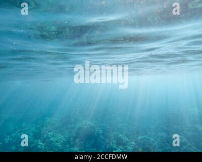 Underwater rays of light with ripples on surface Stock Photo