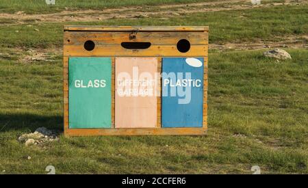 Containers for separate waste collection. wooden waste box on the street.  Stock Photo