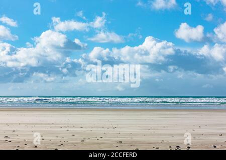 Surf on the sandy beach in Brittany Stock Photo