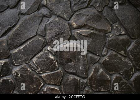 Black stone wall texture. Bali. Indonesia Stock Photo