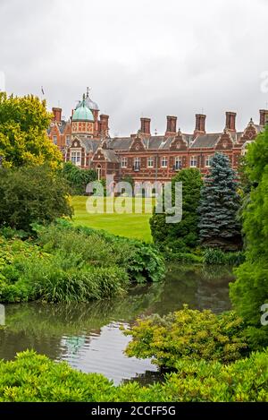 The gardens and large lake at the rear of Sandringham House, a Grade II* listed Victorian built country house set in 20,000 acres of land near the vil Stock Photo