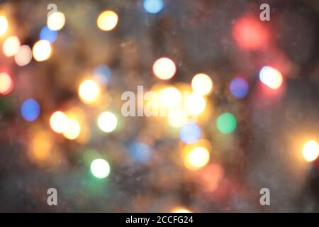 Christmas garlands, abstract blurred background with blurred lights of different colors. Christmas background, backdrop, background. Stock Photo