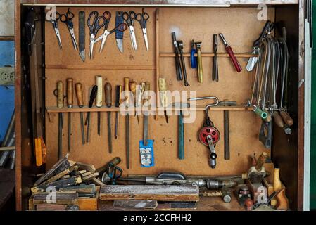 Old carpentry work tools on a wooden wall. Stock Photo
