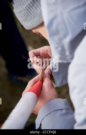 The guy holds in his hands a model of a miniature rocket and prepares it for flight. Stock Photo