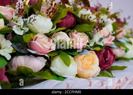 Fragment of a wedding decoration, artificial rose flowers, close-up. Stock Photo