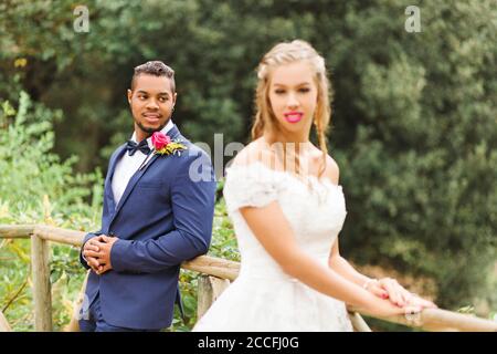 Wedding, newlyweds, young adults, diversity, love, landscape, railing Stock Photo