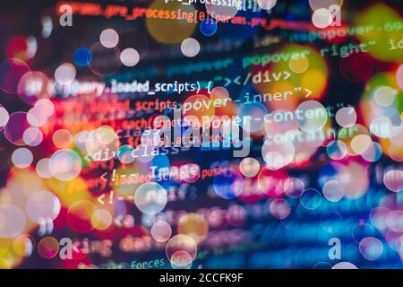 Programmer working in a software develop company office. Digital binary data on computer screen. Computer script typing work. Programming code abstrac Stock Photo
