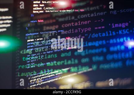 Programmer working in a software develop company office. Digital binary data on computer screen. Computer script typing work. Programming code abstrac Stock Photo
