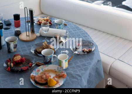 Abandoned messy picnic  table with some food left, outdoor shot Stock Photo