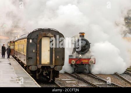 Ex-GWR steam loco 6960 'Raveningham Hall' makes dramatic departure from the engine shed at Minehead, West Somerset Railway Spring Gala, England, UK Stock Photo