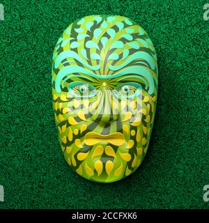 Asian theater mask with colored ornaments in green against a dark green marbled background Stock Photo