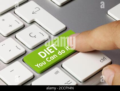 Diet You Can do it Written on Green Key of Metallic Keyboard. Finger pressing key. Stock Photo