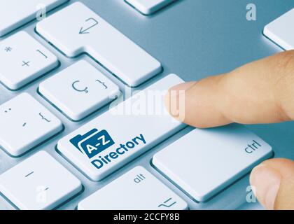 Directory Written on Blue Key of Metallic Keyboard. Finger pressing key. Stock Photo