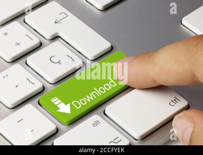 Download Written on Green Key of Metallic Keyboard. Finger pressing key Stock Photo