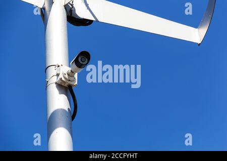 Twin security cameras on a pole against a blue sky. Stock Photo