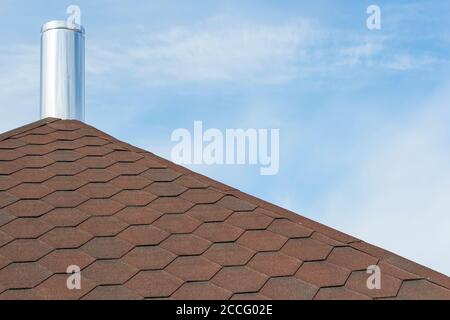 Chimney pipe from stainless steel on the roof of the house. Stock Photo