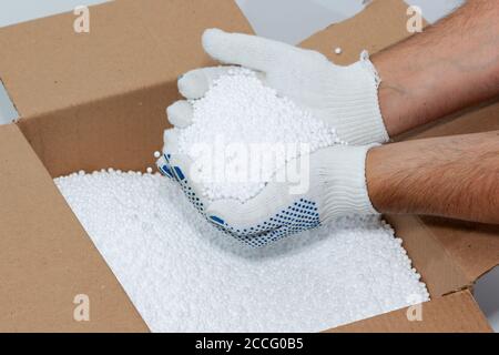 Round Styrofoam balls in my hands, the texture for the background. Environmental protection Stock Photo